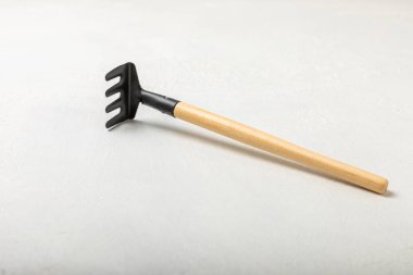 Garden tools on a light concrete background. Space for text. Space for copy. Top view. Gardening concept.Working in the garden.Hobby. Garden rake on a textured background.