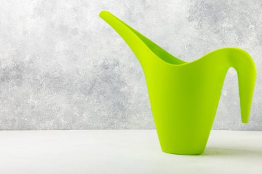 Garden tools on a light concrete background. Space for text. Space for copy. Top view. Gardening concept.Working in the garden.Hobby. Watering can for watering on a textured background.