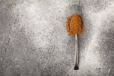 Ingredients for making coffee - coffee beans, ground and instant coffee on a black textured background. Caffeine. Decaffeinated coffee. Aroma energy hot drink. Place for text, space for copy.