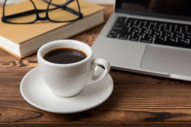 Desk with laptop, glasses, notepads and a cup of coffee on the desktop.Workspace with copy space. Mocap. Business concept. Place for text. Flat lay