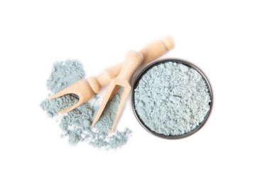 Blue spirulina powder in bowl isolated on white background. SUPERFOOD