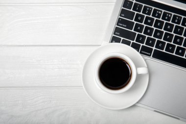 A laptop with a cup of strong aroma coffee on a working office desk. Workspace with copy space. Mocap. Business concept. Place for text. Flat lay