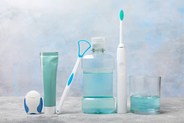 Electronic Ultrasonic Toothbrush Mouthwash Floss Tongue Cleaner Toothpaste Blue Textured — Stock Photo, Image