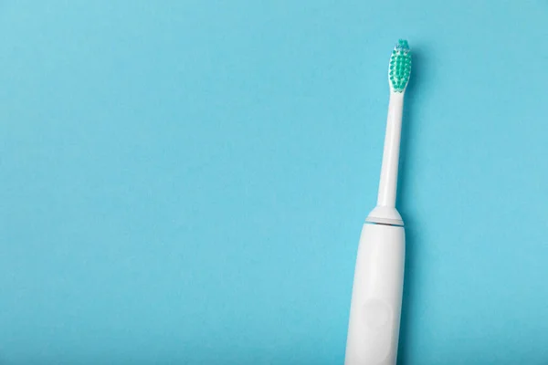 Electronic ultrasonic toothbrush on a blue background.Smart electric toothbrush. Items for dental care and caries prevention. Dentistry concept. Modern technologies for health. Healthy teeth.Medical robot.