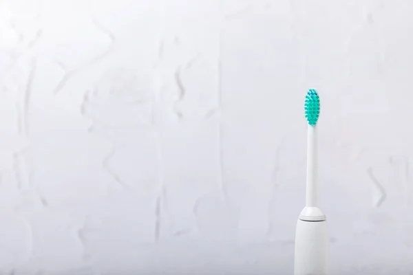 Smart electric toothbrush. Modern technologies for health. Healthy teeth. Dentistry concept. medical robot. Charged via powerbank and controlled by an app on a smartphone. Oral hygiene.copy space.