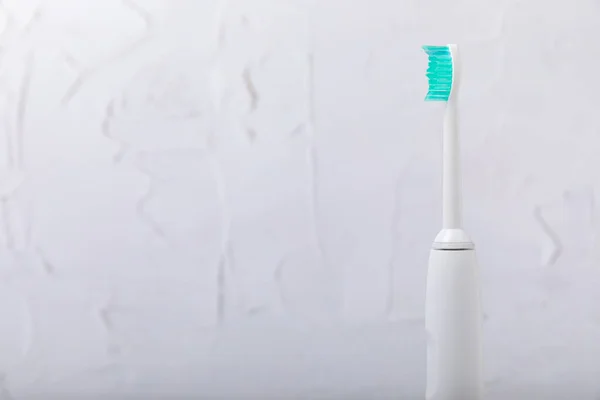 Smart electric toothbrush. Modern technologies for health. Healthy teeth. Dentistry concept. medical robot. Charged via powerbank and controlled by an app on a smartphone. Oral hygiene.copy space.