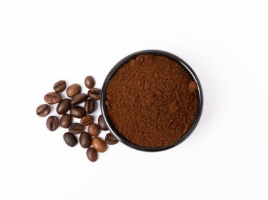 Bowl of ground coffee and beans isolated on a white background.