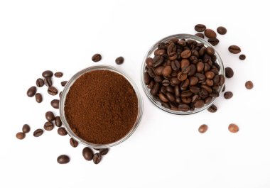 Bowl of ground coffee and beans isolated on a white background.