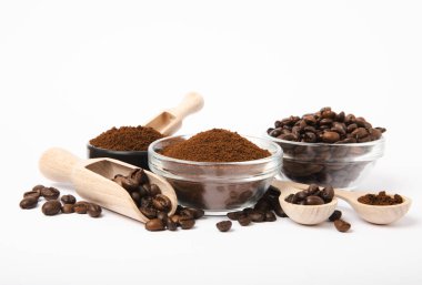 Bowl of ground coffee and beans isolated on a white background.