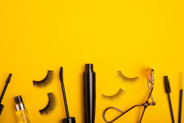 Composition False Eyelashes Mascara Eyelash Brushes Eyelash Curlers Yellow Background — Stock Photo, Image