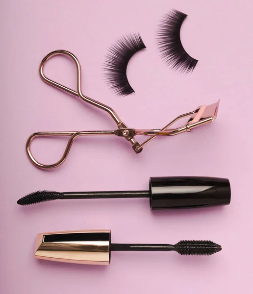 stock image Composition with false eyelashes, mascara and eyelash brushes, eyelash curlers on a lilac background. Makeup artist tools. Beauty concept. Compose. Place for text. Place to copy. Flatley. MOCAP.