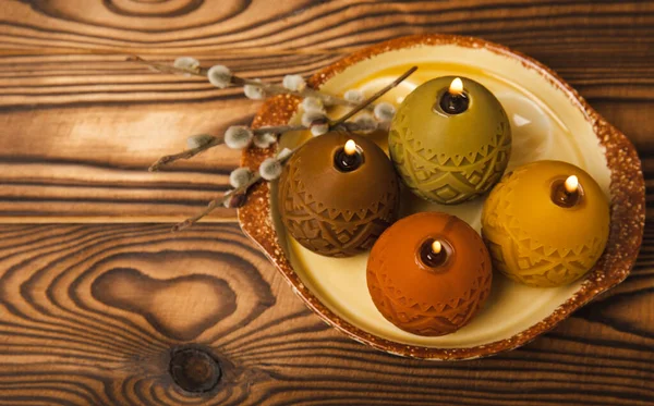 Osterkerzen Eier Einem Teller Auf Einem Braunen Tisch Mit Weidenzweigen — Stockfoto