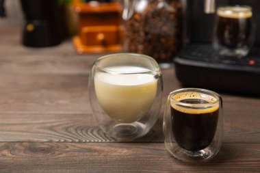 Bardakta sade kahve ve krema. Espressoya krema ya da süt dök. Siyah masa arkasında kahve içeceğiz. Barista. Kahve evi konsepti. Metin için yer.