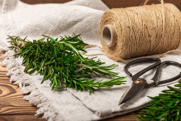 stock image Branches of fresh rosemary on a brown texture background. Spicy spices. Seasoning for meat and fish. Cooking concept. RECEPT. Close-up. place for text.