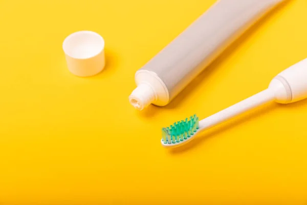 Sonic electric toothbrush, toothpaste, mouthwash, dental floss and tongue cleaner on yellow background. Oral hygiene. Dental care.Dentistry concept.Place for text.Place for copy.