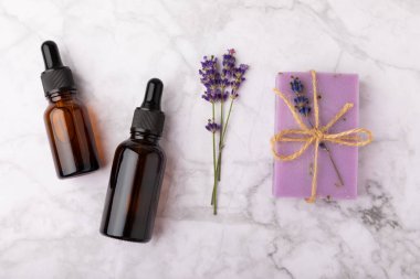 Lavanta spreyi, deniz tuzu, lavanta çiçekleri, aroma mumu, vücut kremi ve el yapımı sabun. Mermer arka planda lavanta çiçekleri olan doğal bitkisel kozmetik ürünleri. Rahatlayın. Güzellik tedavileri..