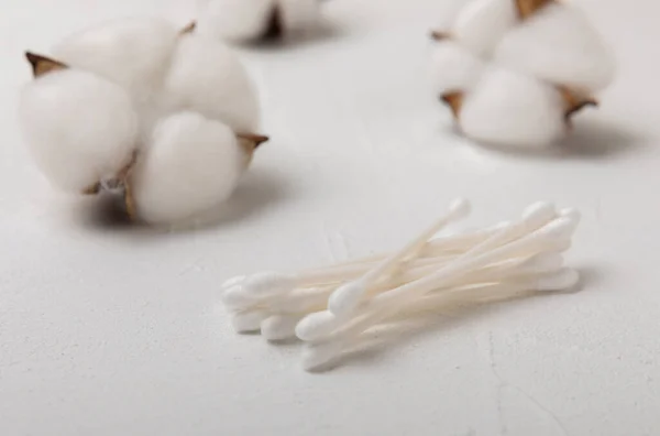 stock image Cotton buds on a textured cement background. Cotton swab on a white background. Sticks for hygiene of the nose and ears. Plastic cotton swabs. Cotton wool. Space for text.Space for copy.