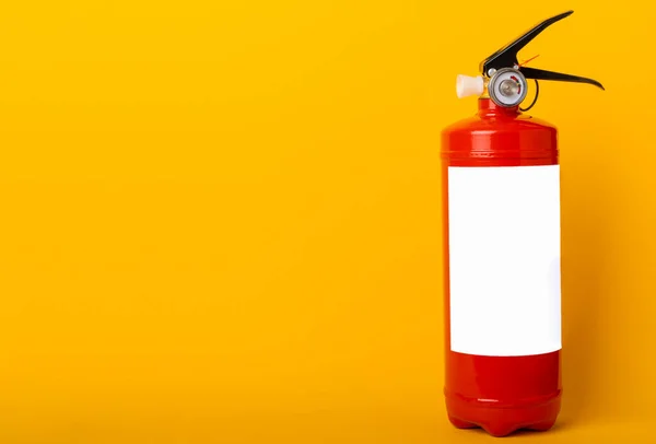 Fire extinguisher on a yellow background . Fire protection, home fire extinguisher. home security concept. Place for text. Copy space.banner