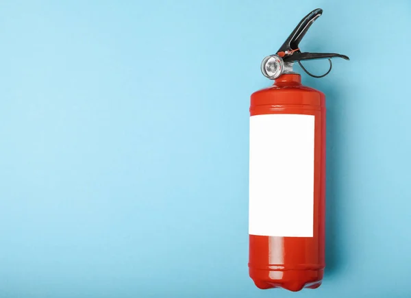 Fire extinguisher on a blue background . Fire protection, home fire extinguisher. home security concept. Place for text. Copy space.banner