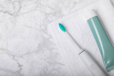 Diş fırçası ve diş macunu tüpü mermer arka planda fotokopi alanı ile birlikte. Düz yatıyordu. Ağız temizliği. Ağız bakım kiti. Dişçi konsepti. Mesaj için yer. Kopyalanacak yer.