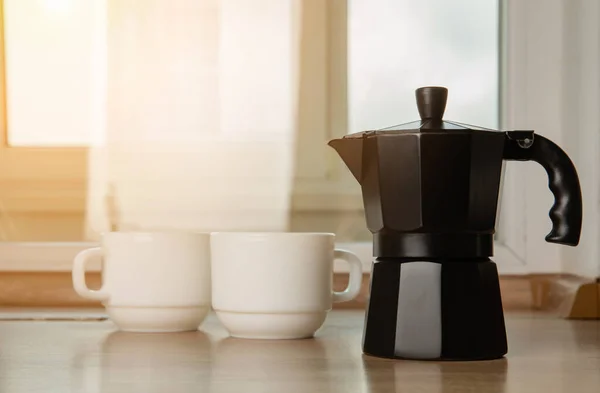 stock image Moka pot on the background of the kitchen. Coffee maker with hot fragrant coffee on the table. Place for text. Copy space