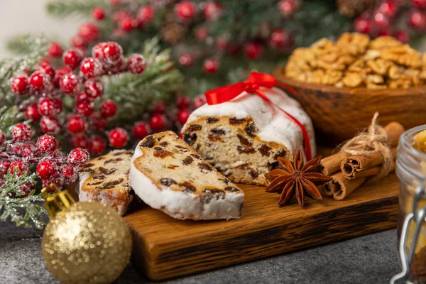 stock image Christmas stollen on wooden background. Traditional Christmas festive pastry dessert. Stollen for Christmas.Christmas fruit cake, pudding on a white plate.Traditional German Christmas pastry.