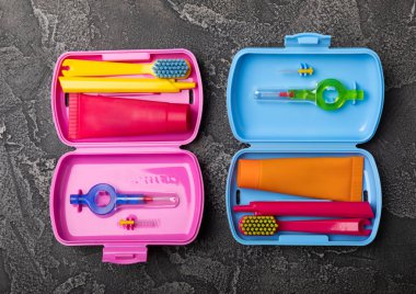 Oral care.Travel set with a toothbrush, toothbrush and toothpaste in a case.Composition on a textural bright background. Dentist concept. Flat lay. copy space.Place for text