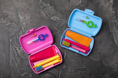 Oral care.Travel set with a toothbrush, toothbrush and toothpaste in a case.Composition on a textural bright background. Dentist concept. Flat lay. copy space.Place for text