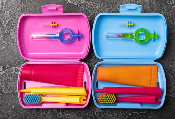 Oral care.Travel set with a toothbrush, toothbrush and toothpaste in a case.Composition on a textural bright background. Dentist concept. Flat lay. copy space.Place for text