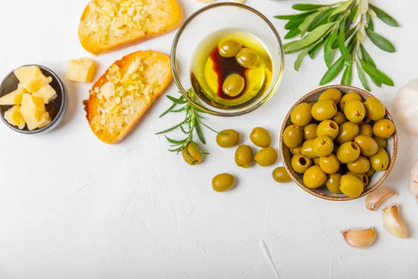 stock image Italian ciabatta bread with olives, garlic, parmesan and rosemary on a light concrete background. Tasty food. Aperitif. Place for text. copy space. Delicacy. Bon appetit.