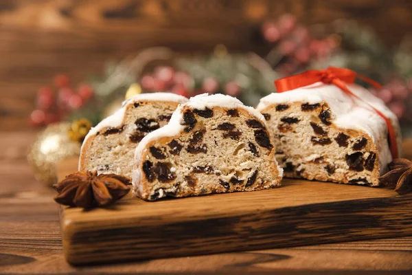 stock image Christmas stollen on wooden background. Traditional Christmas festive pastry dessert. Holiday concept. Dessert, cake, pie with marzipan, nuts and dried fruits. Stollen for Christmas. Spicy pastries.