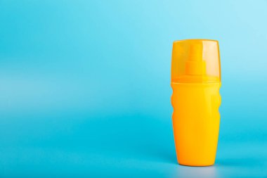 Güneş kremi. Kavanoz, parlak mavi arka planda SPF kremi ile kozmetik tüp. Cilt bakımı ve ultraviyole ışınlardan korunma kavramı. Fotoğrafçılık. Güneş kremi seçimi. Metin için yer. Boşluğu kopyala.