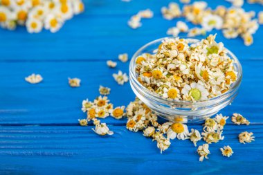 Tahta bir masanın üzerinde papatya çiçekleri. Rahatlatıcı papatya çayı. Bitkisel içecek. Düz plan. Ders için alan. Kopya alanı. Tıbbi önleme ve bağışıklık konsepti. Halk alternatif tıbbı.