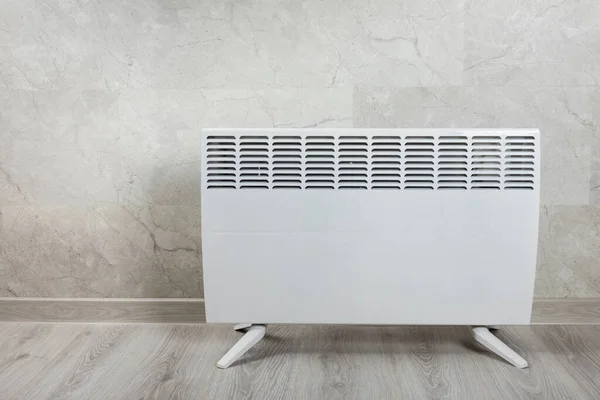 Modern radiator at home. Central heating system.Heating radiator, White radiator in the apartment. Expensive heating costs concept, close-up.Heating season. Heating.Space for text.MOCKUP