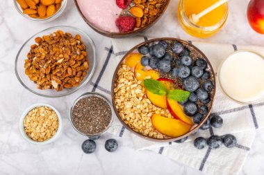 Granola kasesi. Yulaf ezmeli yoğurt, taze böğürtlen, spirulina ve chia çekirdeği. Sağlıklı yiyecekler. Lezzetli bir kahvaltı. Çilekli yoğurt, ahududu, yabanmersini, şeftali, nane ve mendal. Boşluğu kopyala.