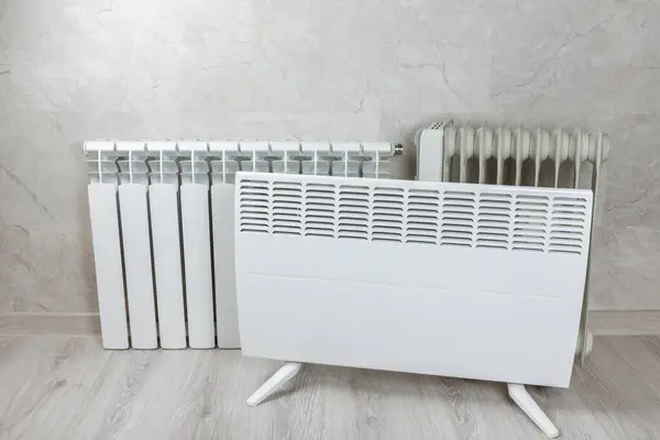 Different types of radiators. Heating systems store.Modern radiator at home. Central heating system. radiator, White radiator in the apartment.Expensive heating costs concept, close-up.Heating season.