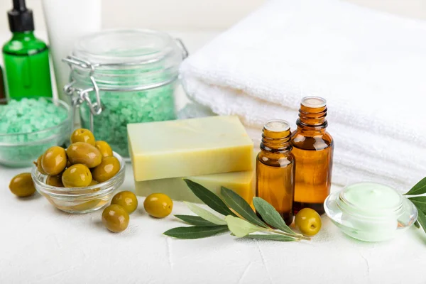 Olive Spa. Essential oils, face and body cream, scrub, sea salt, handmade soap with olive oil extract. Natural cosmetic. Beauty concept. Cosmetic tube. Space for text.Copy space