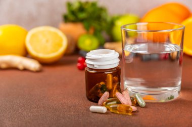 Vitaminler ve takviyeler. Arka planda bulunan bir kavanozdaki vitamin haplarının çeşitliliği. Taze ve sağlıklı meyveli multivitaminler. Yiyecek takviyeleri. Düz yatıyordu. Metin için boşluk. Boşluğu kopyala