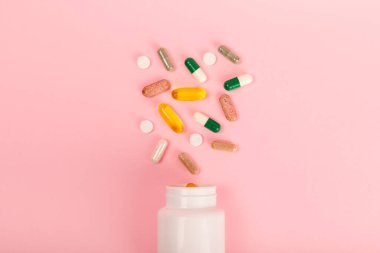 Vitaminler ve takviyeler. Arka planda bulunan bir kavanozdaki vitamin haplarının çeşitliliği. Taze ve sağlıklı meyveli multivitaminler. Yiyecek takviyeleri. Düz yatıyordu. Metin için boşluk. Boşluğu kopyala