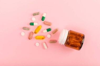 Vitaminler ve takviyeler. Arka planda bulunan bir kavanozdaki vitamin haplarının çeşitliliği. Taze ve sağlıklı meyveli multivitaminler. Yiyecek takviyeleri. Düz yatıyordu. Metin için boşluk. Boşluğu kopyala
