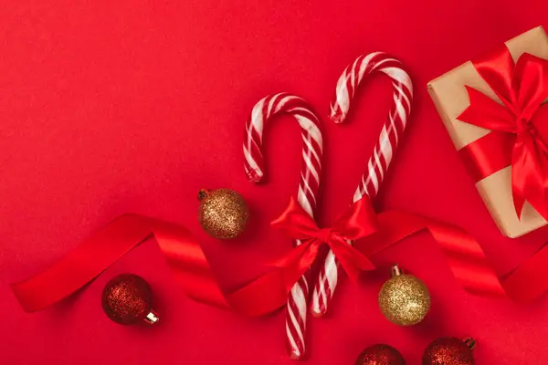 赤い背景にクリスマスキャンディー缶 ホリデーグリーティングカード クリスマスと年末年始のコンセプト ウィンター フラットレイ トップビュー コピースペース — ストック写真