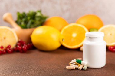 Vitaminler ve takviyeler. Arka planda bulunan bir kavanozdaki vitamin haplarının çeşitliliği. Taze ve sağlıklı meyveli multivitaminler. Yiyecek takviyeleri. Düz yatıyordu. Metin için boşluk. Boşluğu kopyala