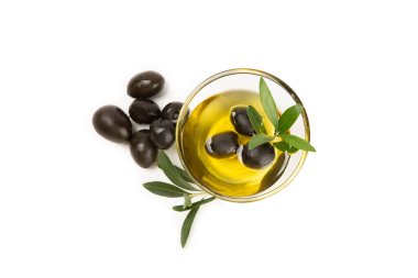 Bir kase taze zeytinyağı ve beyaz arka planda yapraklı zeytin. Cam kasede nefis zeytinyağı. Zeytin yağı şişesi.