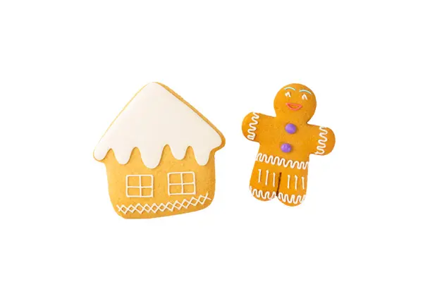 Merry Christmas! Gingerbread man cookies and gingerbread house with icing isolated on white background. Atmospheric Christmas sweets. Gingerbread. Christmas cookies.