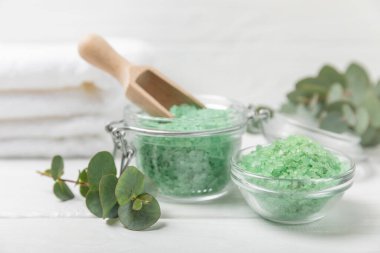 Kozmetik deniz tuzu aromalı ve okaliptüs özlü taze aromatik okaliptüs dallı ahşap bir arkaplan. Spa konsepti. Banyo tuzu. Yakın plan. Metin için boşluk. Vücut bakımı. Boşluğu kopyala