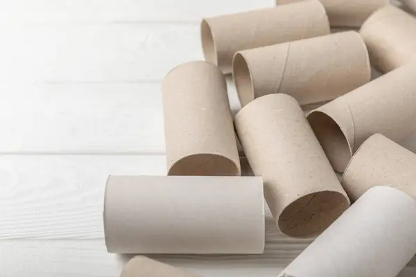 Empty toilet paper roll. Rolls of toilet paper on a white background. Paper tube of toilet paper. Place for text. Copy space. Flat lay. Eco-friendly reuse recycle