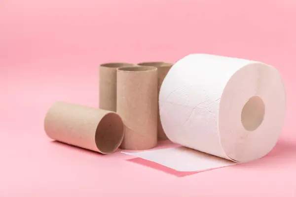 Empty toilet paper roll. Empty toilet paper rolls  for on pink background. Paper tube of toilet paper. Place for text. Copy space. Flat lay. Eco-friendly reuse recycle