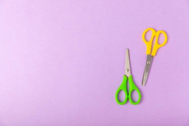 Renkli bir arka planda parlak çocuk makası. Kırtasiye malzemeleri. Okul için mallar. Mesaj için yer. Boşluğu kopyala. Üst görünüm