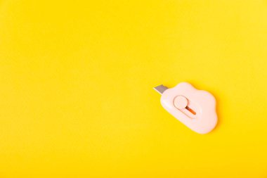 Renkli kâğıt üzerinde kırtasiye bıçağı. Plastik kırtasiye bıçağı. Okul kırtasiyesi konsepti. Kağıt kesmek için plastik renkli kırtasiye bıçakları. Mesaj için yer. Boşluğu kopyala. Üst görünüm