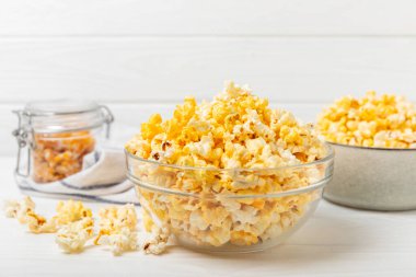 Tahta arka planda lezzetli patlamış mısır. Sinema ve eğlence anlayışı. Patlamış mısırlı film gecesi. Peynir ve patlamış mısır. Lezzetli aperatif, aperatif. Mesaj için yer. Uzayı kopyala. Banner